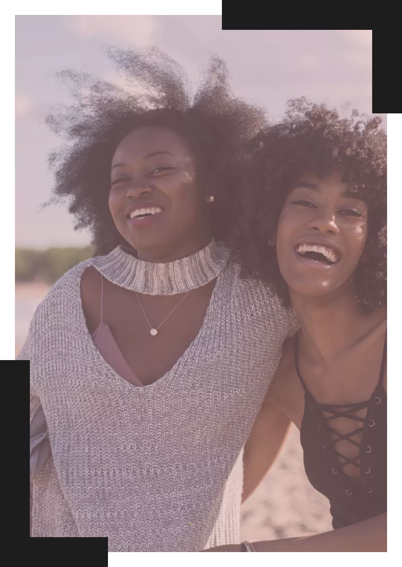 Two Black woman laughing with each other