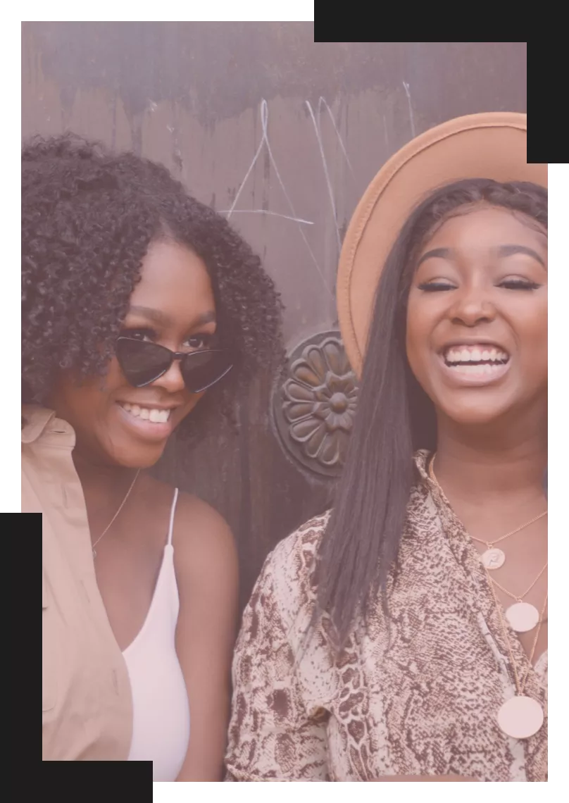 Two Black woman laughing with each other