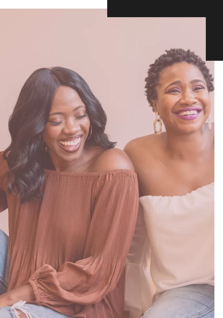 Two Black woman laughing with each other